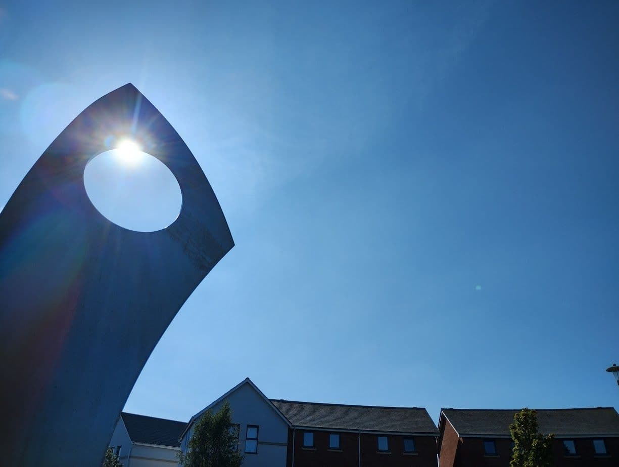 Sunlight shining through the arch sculpture